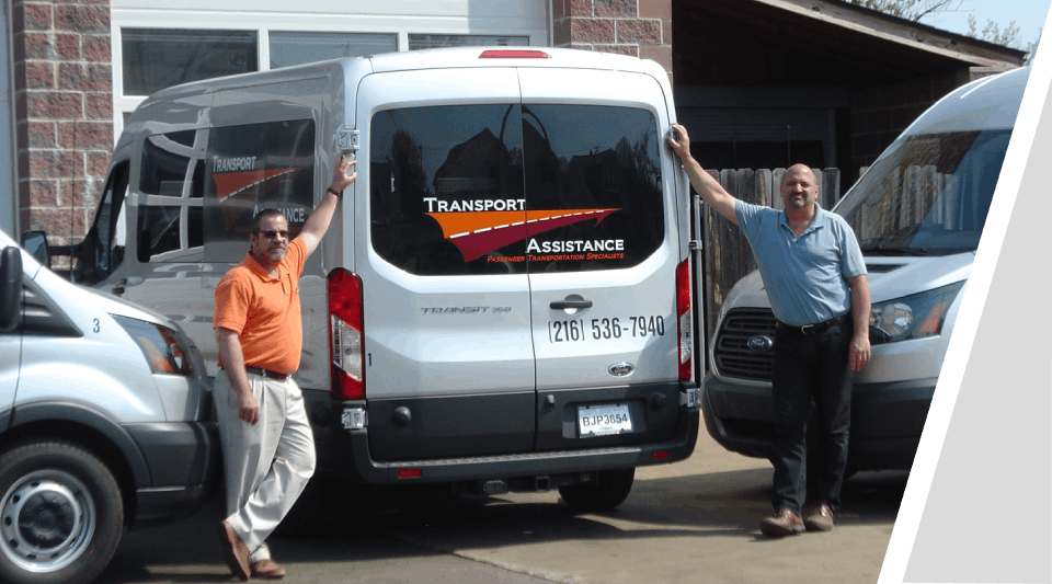 Two men standing in front of a van.